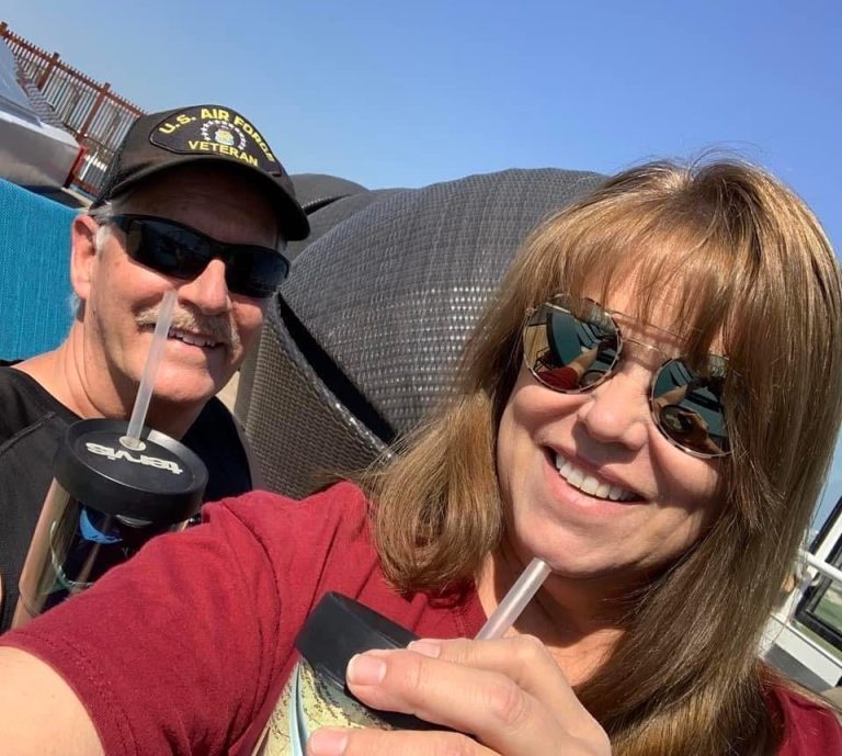 Barb and Ken enjoying a drink on a cruise.